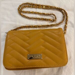 Bebe Sophia quilted small crossbody bag w/ a gold chain shoulder strap. Mustard